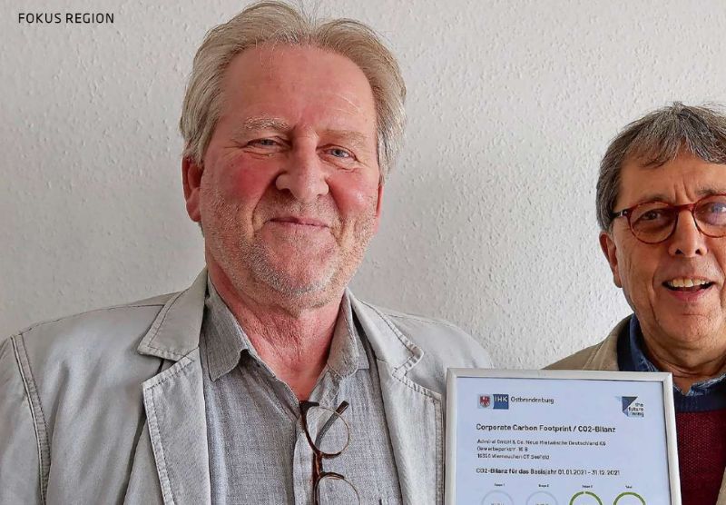 Die Mitarbeitenden von Admiral halten das CO2-Bilanz Zertifikat von The Future Living stolz in den Händen.